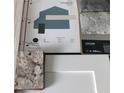 A professionally designed color scheme featuring coordinated paint, stone, and countertop selections at 14351 Carolina Chickadee Rd, Weeki Wachee, FL 34614