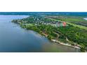 Stunning aerial view of a waterfront community with mature trees and lush landscaping at 205 Bengal Cir, Oldsmar, FL 34677