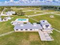 Stunning aerial view of expansive horse property, fenced pastures, pool, and outbuildings at 15200 Rawls Rd, Sarasota, FL 34240