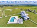 Expansive property showcasing a luxurious pool, manicured lawns, and a beautifully designed home at 15200 Rawls Rd, Sarasota, FL 34240