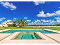 Inviting pool and spa area surrounded by lush greenery, perfect for relaxation and entertainment at 15200 Rawls Rd, Sarasota, FL 34240