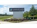 Attractive Sandal Key community sign surrounded by lush landscaping, creating a welcoming entrance at 10414 Tucker Rd, Weeki Wachee, FL 34613