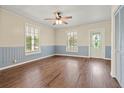 The living room boasts hardwood floors, a ceiling fan, and classic trim, exuding timeless charm at 304 Highland St, Brooksville, FL 34601