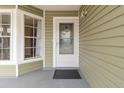 Inviting front entrance featuring a glass door, large window, and neutral siding at 14150 Prospect St, Spring Hill, FL 34609