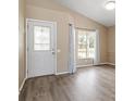Bright living room with wood floors, large windows, and fresh neutral paint at 14150 Prospect St, Spring Hill, FL 34609