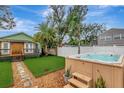 The backyard features a modern hot tub, outdoor seating, with well-manicured artificial grass at 2715 14Th N Ave, St Petersburg, FL 33713