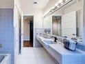 Bathroom featuring tile countertop, large mirror, vanity, and shower at 1137 Indian Rocks S Rd, Largo, FL 33770