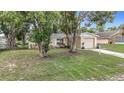 Cozy one-story home surrounded by mature trees and lush landscaping at 7318 Tranquil Dr, Spring Hill, FL 34606