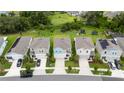 A residential community view of neatly landscaped homes and driveways on a sunny day at 5528 Summer Sunset Dr, Apollo Beach, FL 33572