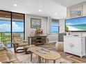 Living room boasts ocean views, comfy seating, and an open floor plan at 15316 Gulf Blvd # 301, Madeira Beach, FL 33708
