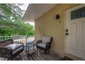 Small balcony with wicker seating, a small table, and front door access at 6628 1St N St, St Petersburg, FL 33702