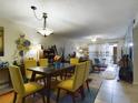 Dining room with yellow chairs and view of living room at 2625 State Road 590 # 124, Clearwater, FL 33759