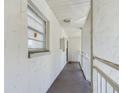 Hallway with access to condo unit and balcony at 2625 State Road 590 # 124, Clearwater, FL 33759