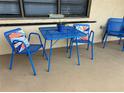 Inviting outdoor patio area with a vibrant blue metal table and chairs at 24 Quails Run Blvd # 3, Englewood, FL 34223