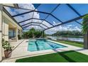 Inviting pool and spa with a covered lanai and lake view at 5330 Silver Sun Dr, Apollo Beach, FL 33572