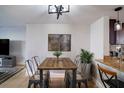 Modern dining area featuring a rustic wood table and metal chairs at 4837 Puritan Cir # 2505, Tampa, FL 33617