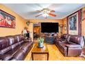 Living room with brown leather couches and a fireplace at 7616 S Swoope St, Tampa, FL 33616