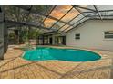 Inviting kidney-shaped pool with a covered patio and spa at 2892 North Rd, Clearwater, FL 33760