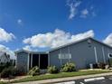 Gray house with landscaped yard and screened patio at 3300 Loveland Blvd # 502, Punta Gorda, FL 33980