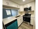 Modern kitchen with white cabinets and stainless steel appliances at 7108 Waterside Dr # 103, Tampa, FL 33617