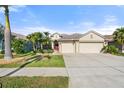 Three-car garage and manicured lawn enhance this home's curb appeal at 1820 Mira Lago Cir, Ruskin, FL 33570