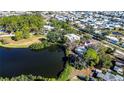 House nestled by a lake, surrounded by other homes at 6626 1St N St, St Petersburg, FL 33702