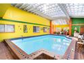 Bright, colorful solarium with a large indoor pool at 6626 1St N St, St Petersburg, FL 33702
