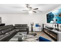 Spacious living room featuring modern décor, sleek furniture, and a fireplace with a large screen tv above it at 5327 New Friendship Pl, Tampa, FL 33619