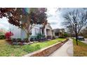 Lovely home with a manicured front lawn, garden, and inviting front porch at 5406 Fishhawk Ridge Dr, Lithia, FL 33547