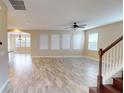 Spacious living room featuring stylish tile floors, natural light, and ceiling fan at 5406 Fishhawk Ridge Dr, Lithia, FL 33547