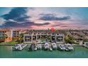 An aerial view showcases waterfront condos, a pool, private boat docks and a beautiful waterfront location at 722 Pinellas Bayway S # 102, St Petersburg, FL 33715