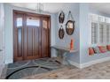 Inviting entryway with wood floors, a decorative rug, and a beautiful wood door with sidelights at 764 S Mccall Rd, Englewood, FL 34223