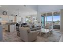 Open-concept living room with water views, wood floors, and stylish furnishings at 764 S Mccall Rd, Englewood, FL 34223