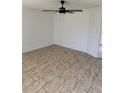 Inviting living room features neutral tile flooring and a modern ceiling fan for added comfort at 166 Dartmouth Nw Dr, Port Charlotte, FL 33952