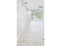 Hallway with tile floors and a sunroom with sliding glass doors at 1433 S Belcher Rd # G13, Clearwater, FL 33764