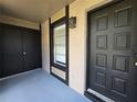 Covered entrance area with tile flooring and an exterior light fixture at 14663 Norwood Oaks Dr # 103, Tampa, FL 33613