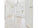 Bright foyer with tile flooring, white trim, and natural light at 10169 Holly Berry Dr, Weeki Wachee, FL 34613