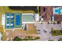 An aerial view showcases the community's tennis and shuffleboard courts, swimming pool, and parking at 341 Outrigger Pl, North Port, FL 34287