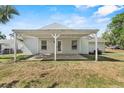 Spacious backyard featuring a covered patio, perfect for outdoor entertaining at 1103 W Dixie St, Plant City, FL 33563