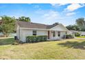 Well-maintained home with a lush green lawn, complemented by mature landscaping at 1103 W Dixie St, Plant City, FL 33563