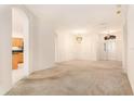 Bright living room boasts neutral walls, carpeted floor, chandelier, and arched doorways at 11924 Northumberland Dr, Tampa, FL 33626