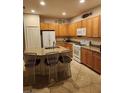 Bright kitchen with granite counters, tile flooring and stainless appliances at 1375 Backspin Dr, Englewood, FL 34223