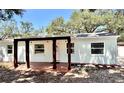 Charming single-story home with a welcoming covered porch and manicured front yard at 4201 S Renellie Dr, Tampa, FL 33611