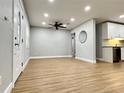 Bright, open-concept living area with modern flooring, a ceiling fan, and ample natural light at 4201 S Renellie Dr, Tampa, FL 33611