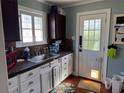 Cozy kitchen features white cabinetry, granite countertops, stainless steel sink, and a window over looking the outdoors at 836 41St N Ave, St Petersburg, FL 33703