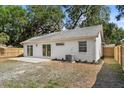 Spacious backyard with a patio area, lawn, and partial fence at 1103 Hardwood Dr, Valrico, FL 33596