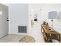 Hallway view with tile floors, leading to the kitchen and featuring a console table at 2700 Bayshore Blvd # 3210, Dunedin, FL 34698