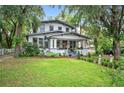 Two-story home with inviting front porch and well-manicured landscaping at 1007 N Wheeler St, Plant City, FL 33563