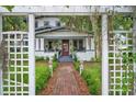 Beautiful two-story home with a red brick walkway through a white pergola at 1007 N Wheeler St, Plant City, FL 33563