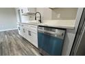 Updated kitchen showcasing white cabinets, quartz countertops, stainless steel appliances, and modern faucet at 1735 Council Dr, Sun City Center, FL 33573